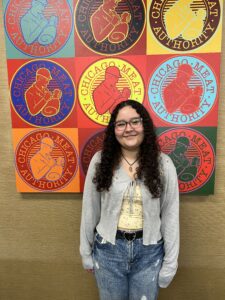 Michelle Montoya stands in front of a Chicago Meat Authority sign